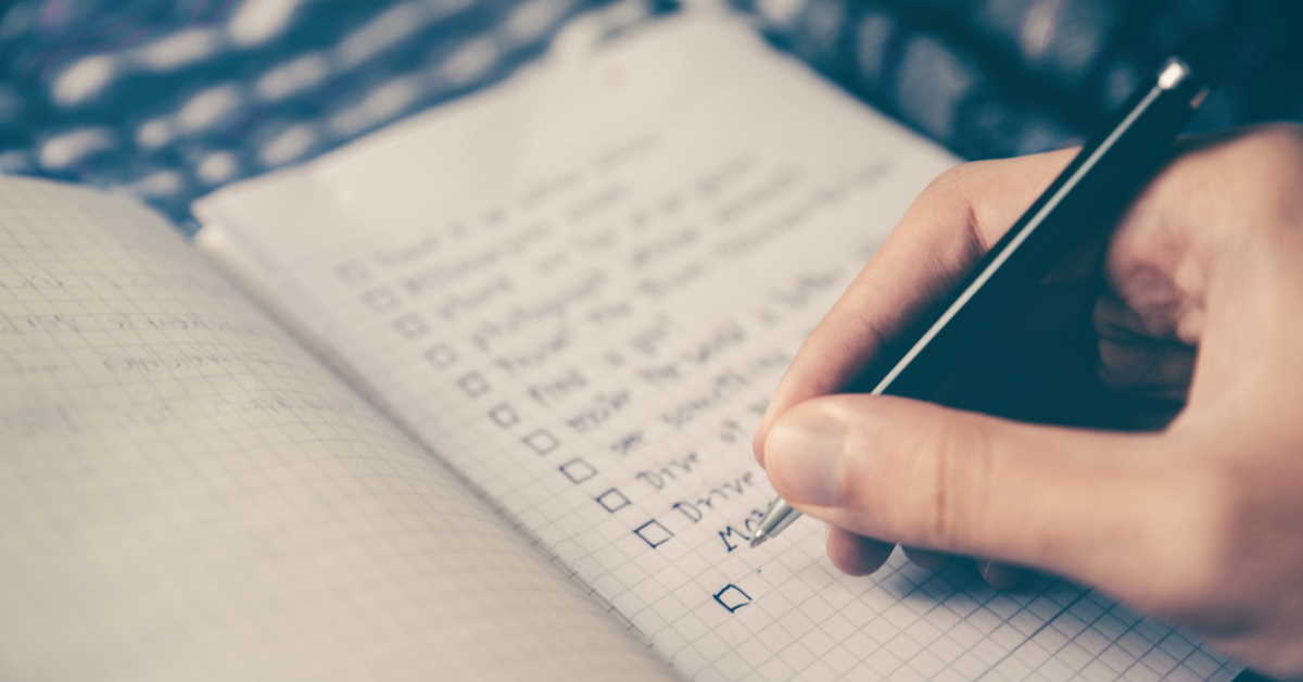 Writing a checklist in a notebook